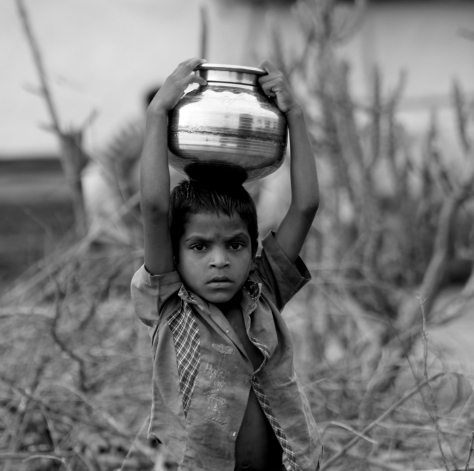 Little boy carrying water!!